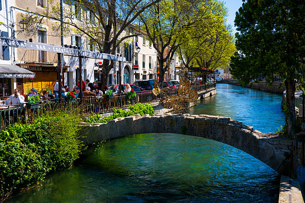 Beautiful French village of Isle sur la Sorgue - People having lunch along the Canals and watermill
